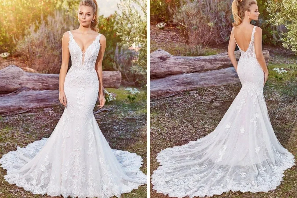 Martin Thornburg Wedding Dresses: 15 Of Our Favorites Side-by-side images showing the front and back of a bride wearing a plunging lace mermaid wedding dress with thin straps, intricate floral appliqués, a fitted silhouette, and an extended lace train, photographed outdoors in a rustic natural setting.