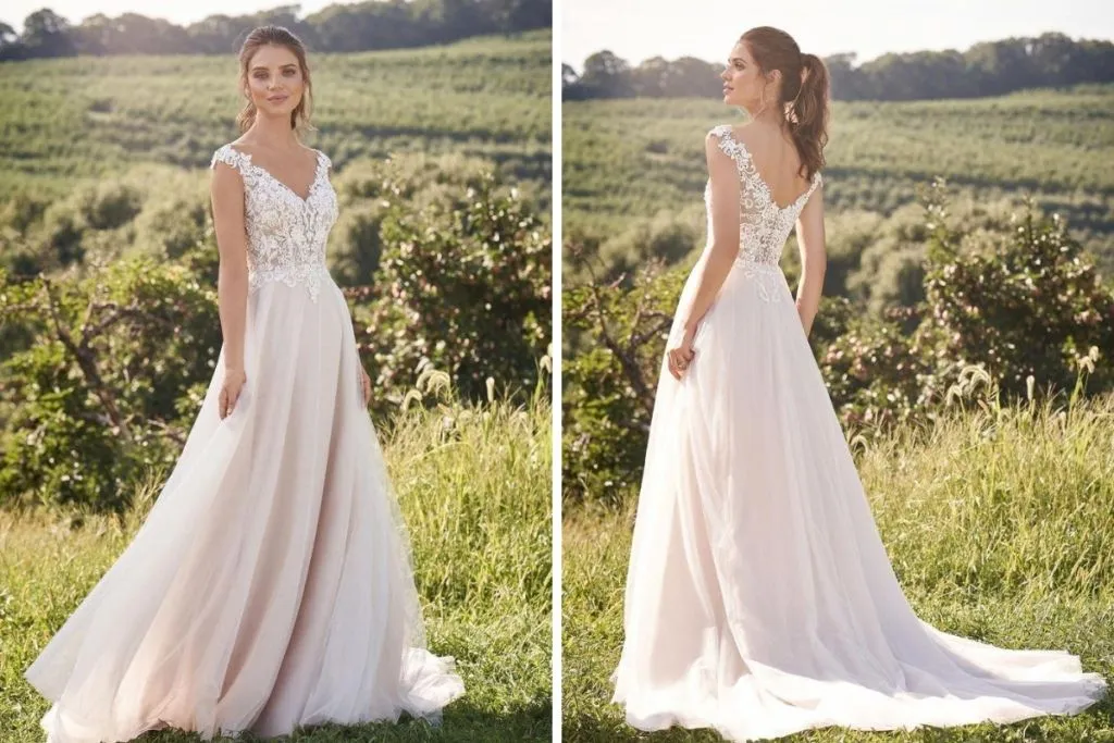 Lillian West Spotlight Event: September 2020 Side-by-side images showing the front and back of a bride wearing a floral lace A-line wedding dress with a deep V-neckline, illusion lace straps, and a flowing tulle skirt, photographed outdoors in a sunlit vineyard setting.