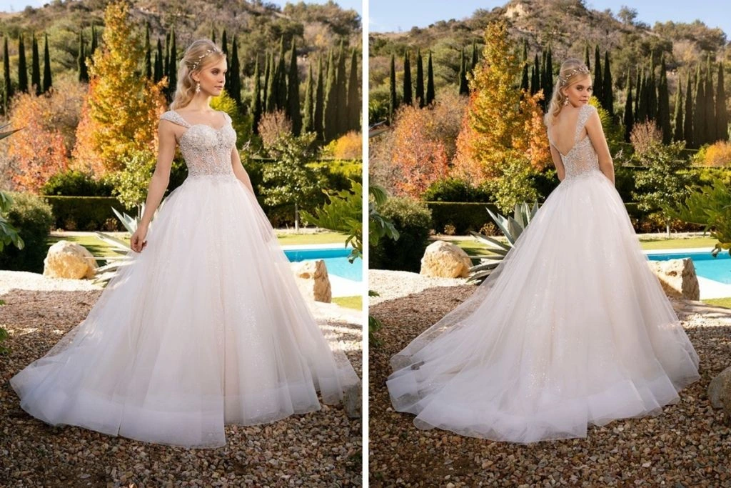 Sneak Peek: Casablanca Bridal Tester Event Front and back views of a shimmering ball gown wedding dress featuring a beaded corset-style bodice, off-the-shoulder straps, and a full glitter tulle skirt, photographed outdoors against lush greenery and fall foliage.