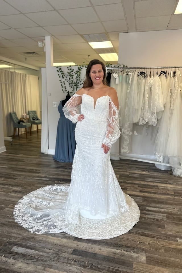 Beaded fit-and-flare wedding dress with sheer off-shoulder sleeves and floral lace train