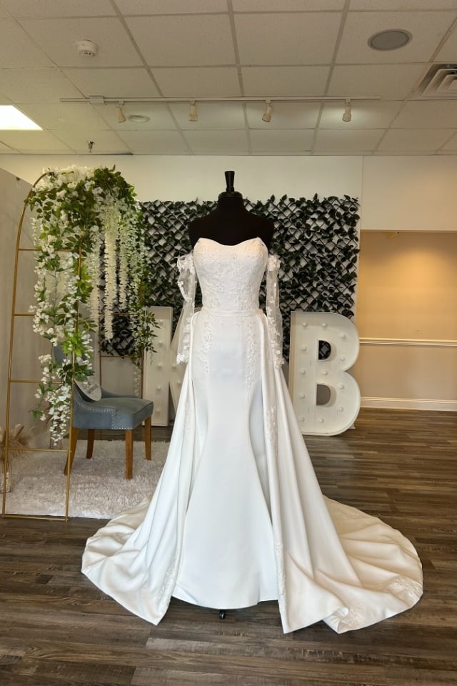 Satin fit-and-flare wedding dress with off-shoulder lace sleeves and sculpted train