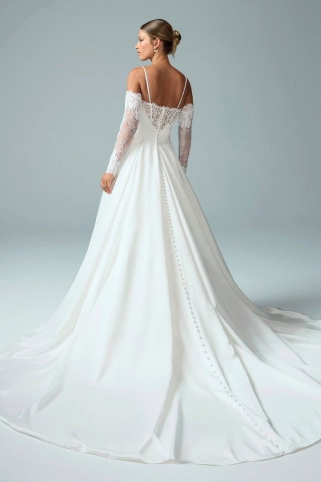 Elegant A-Line Wedding Dress with Scoop Neckline Nim Y3202 A-line wedding dress with scoop neckline, detachable lace gauntlet sleeves, and full skirt with slit.