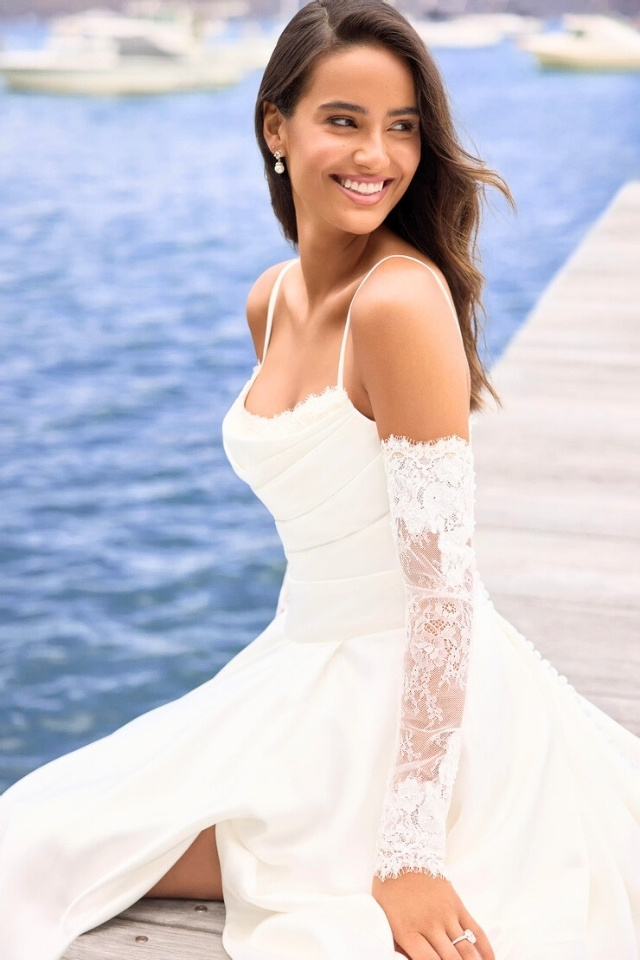 Elegant A-Line Wedding Dress with Scoop Neckline Nim Y3202 A-line wedding dress with scoop neckline, detachable lace gauntlet sleeves, and full skirt with slit.