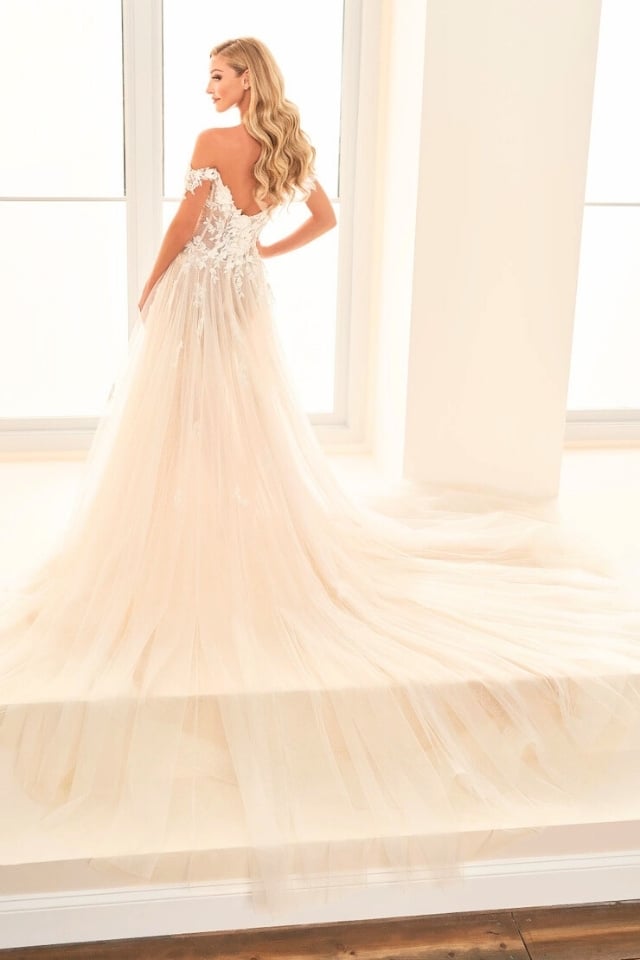E2528 Floral A-Line Wedding Dress Bride wearing the E2528 floral A-line wedding dress with off-the-shoulder 3D lace flowers and a sparkling tulle skirt.