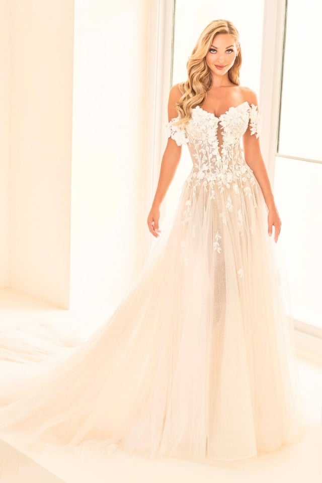 Bride wearing the E2528 floral A-line wedding dress with off-the-shoulder 3D lace flowers and a sparkling tulle skirt.