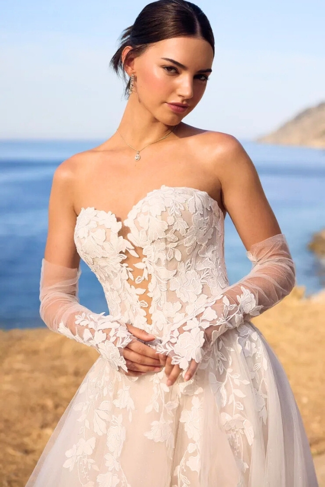 Floral Lace Tulle Ball Gown Wedding Dress Betty Floral lace ball gown wedding dress with sweetheart neckline, skirt slit, and detachable lace gloves.