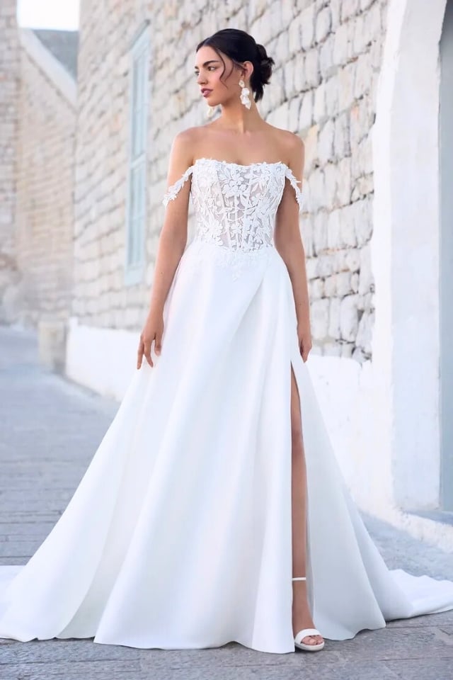 Scoop neck A-line wedding dress with lace bodice, side slit, and clean Mikado skirt with pockets.