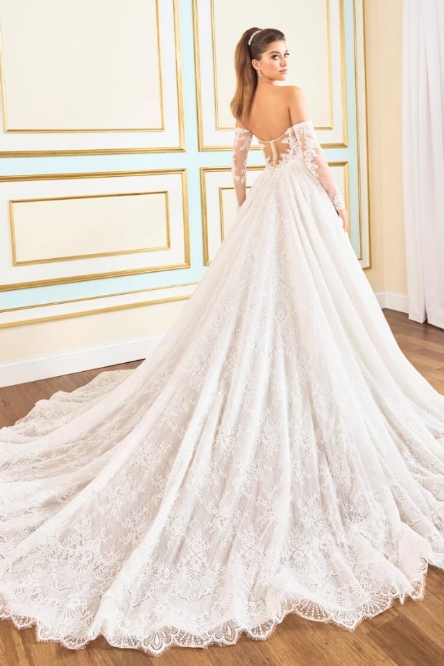 Romantic Lace A-Line Wedding Gown MT9112 Begonia Bride wearing a romantic lace A-line wedding gown with sweetheart neckline and long lace train, styled with detachable long sleeves.