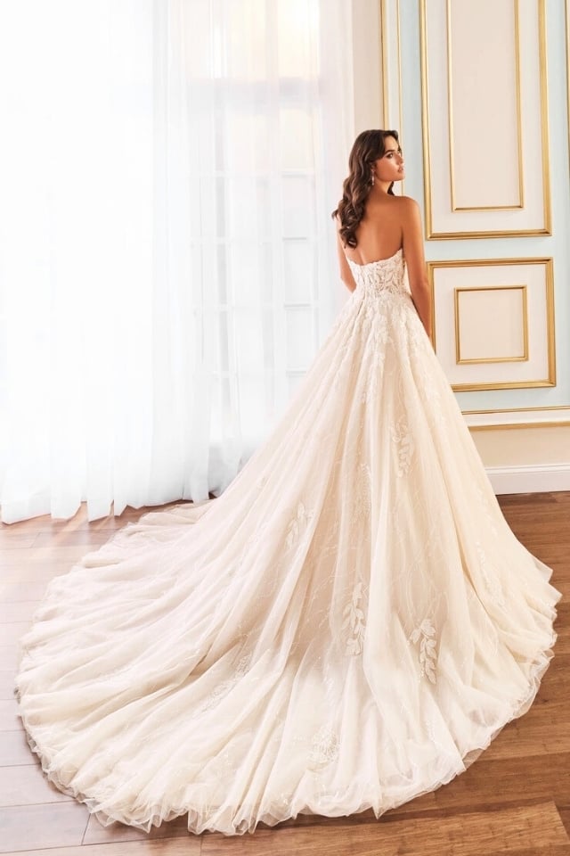 Sparkling Lace Ball Gown Wedding Dress Aamira MT5110 Bride in sparkling tulle ball gown with sweetheart neckline and lace embroidery, wearing off-the-shoulder sleeves and posing in a soft-lit, elegant room.