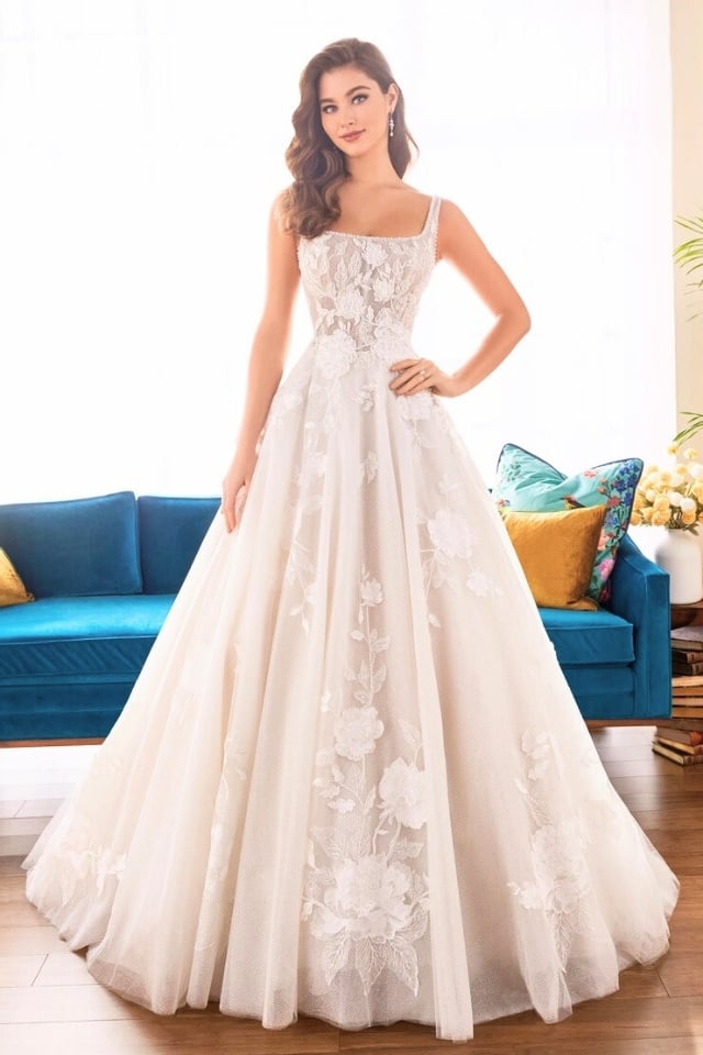 Glitter tulle ball gown with square neckline, floral embroidery, and full skirt.