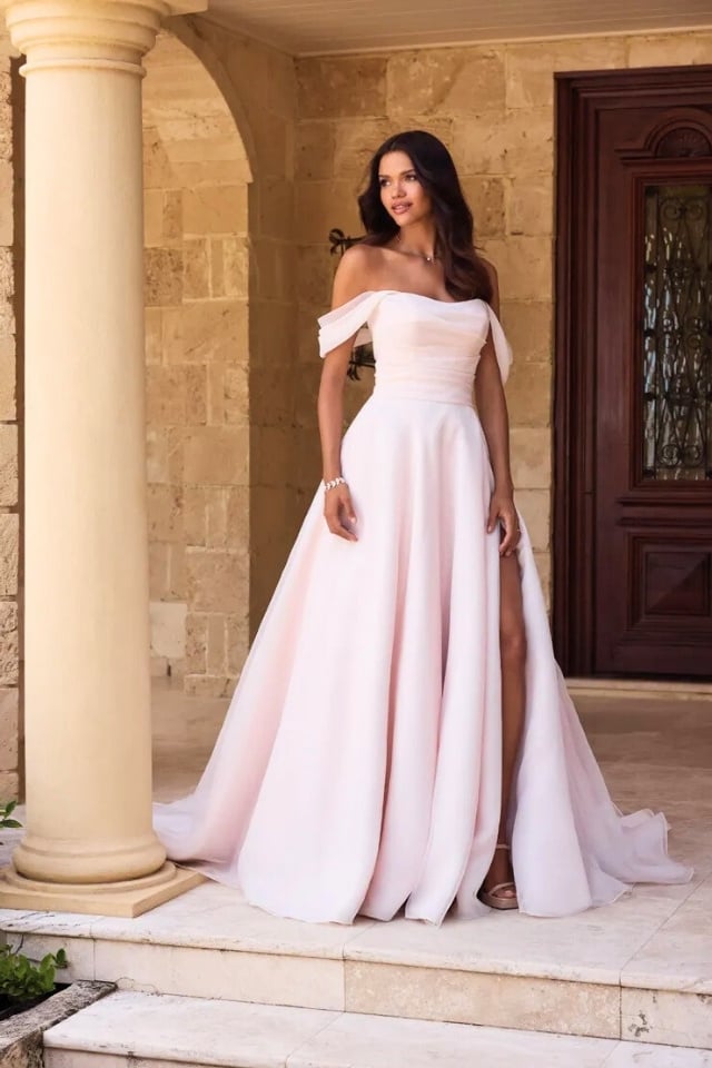 Strapless organza ball gown wedding dress with sweetheart neckline, skirt slit, and hidden pockets.
