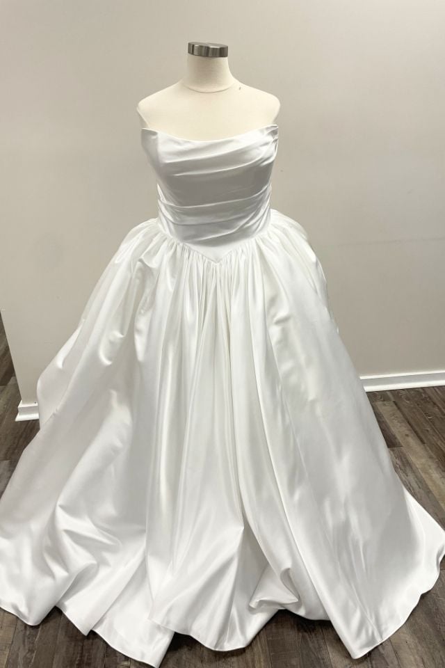 Classic satin ball gown wedding dress with a draped strapless neckline, pleated bodice, and full gathered skirt.