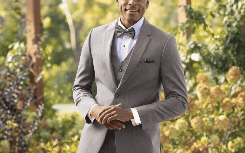 groom wearing a gray tux and bow tie