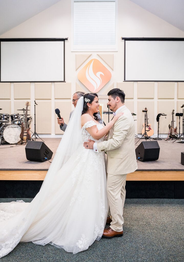 bride and groom smiling at each other
