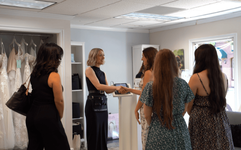 bride and team shaking hands with the stylist