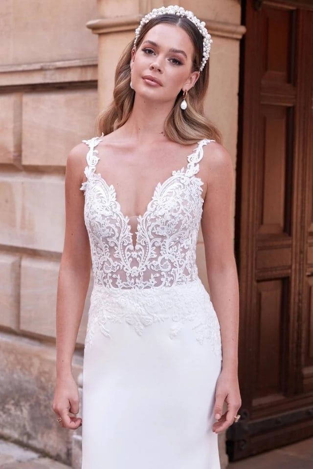 Stretch Crepe Fit-and-Flare Wedding Dress Makenna Stretch crepe fit-and-flare wedding dress with lace bodice, plunge neckline, and sweep train.