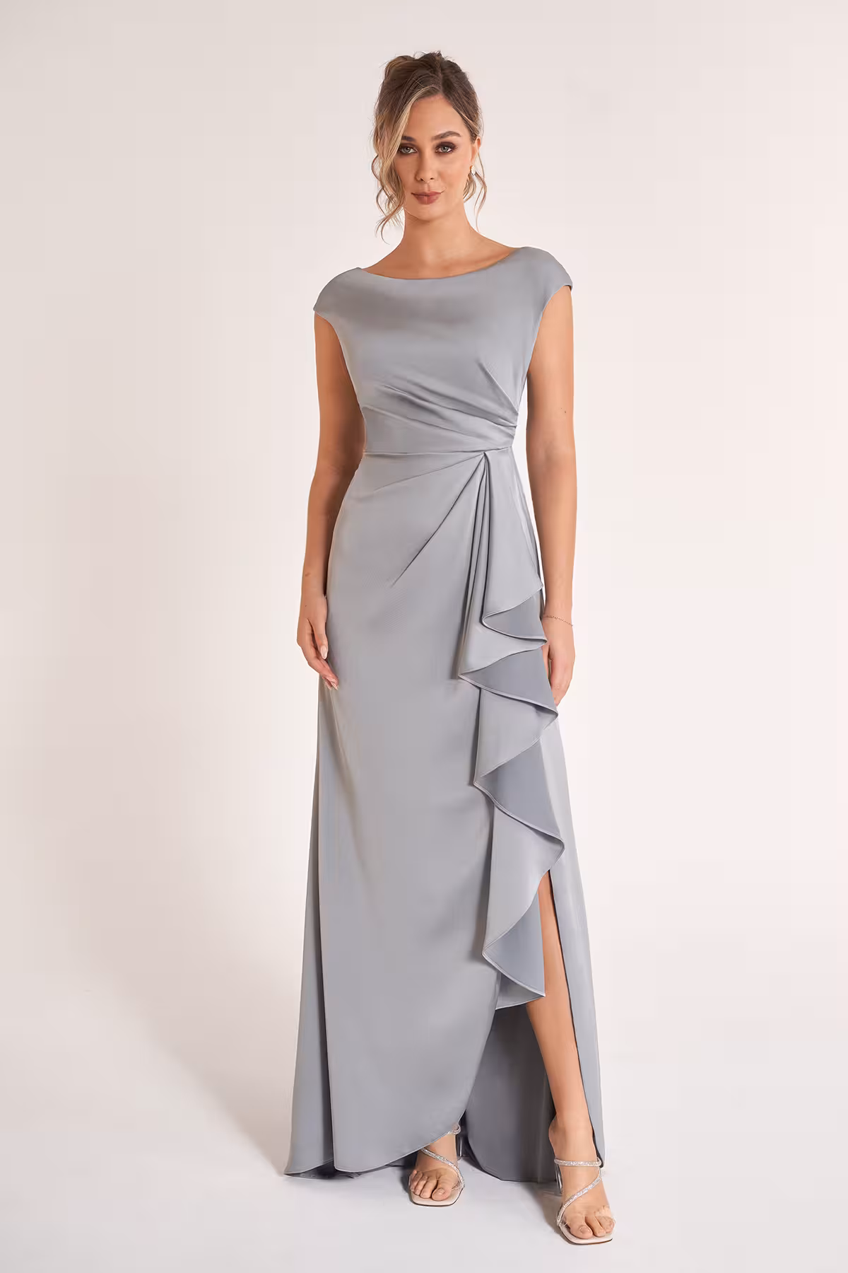 Marsoni off-the-shoulder mother of the bride gown in textured jacquard fabric featuring a fitted silhouette, folded neckline, and cascading ruffle skirt detail in soft blue-gray tones