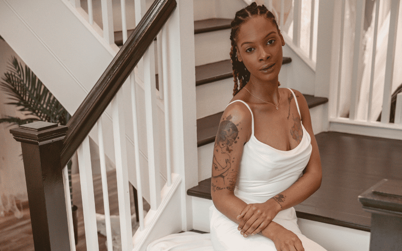 Modern Wedding Dress Styles vs. Classic Bridal Looks: How to Find Your Perfect Gown woman sitting at the stairs