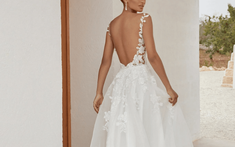 Detachable Wedding Dress Ideas: How to Get Drama for the Aisle and Comfort for the Party bride wearing a wedding gown with detachable wedding train