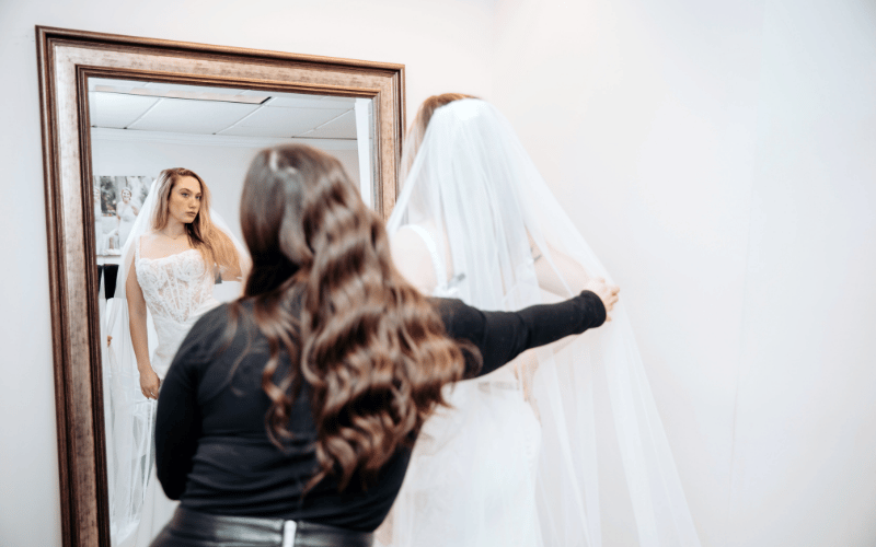 Wedding Dress Questions to Ask Your Stylist During Your Appointment bride and her stylist