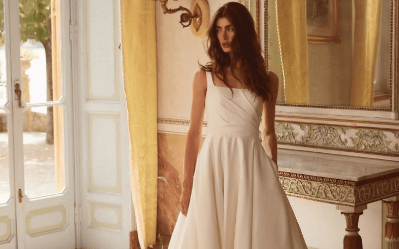 A Square Neckline Wedding Dress Might Be the Detail You Didn’t Know You Wanted woman wearing a wedding dress with square neckline