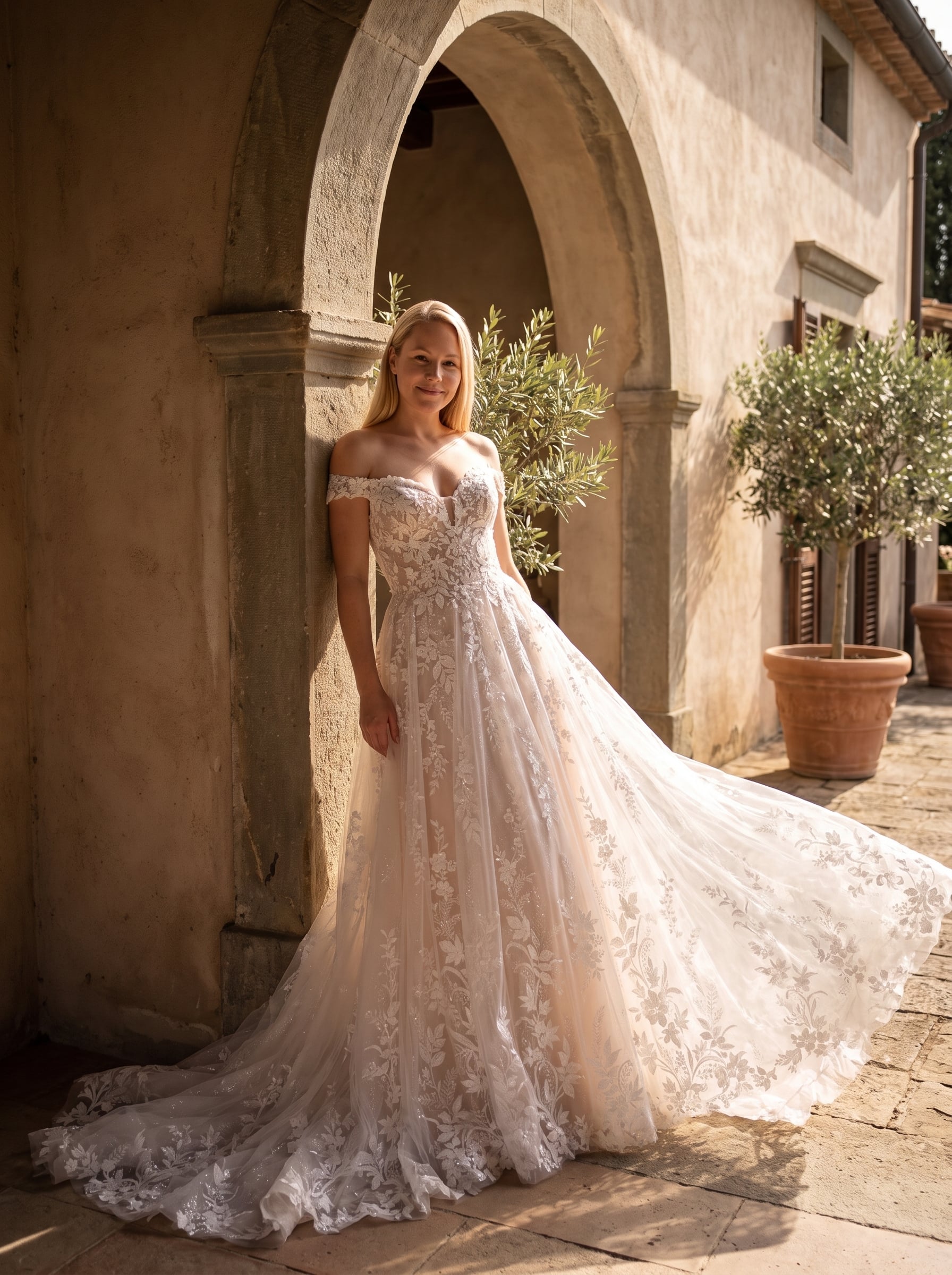 Page Updates & Announcements Off-the-shoulder A-line wedding gown with a sweetheart neckline, allover floral lace appliqués, soft tulle skirt, and a long lace-trimmed train.