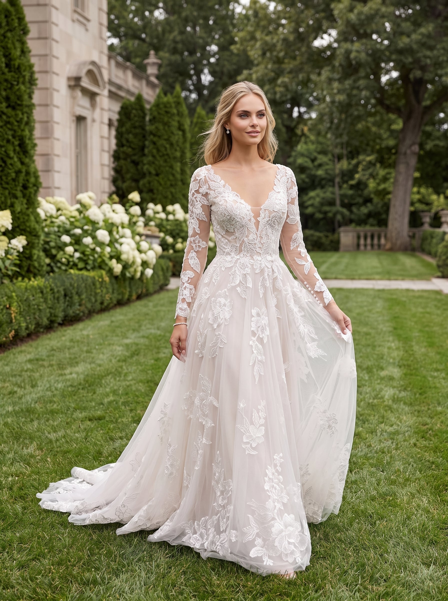 Page Updates & Announcements A-line wedding gown with a V-neckline, sheer long sleeves, and floral lace detailing throughout the bodice, skirt, and train.